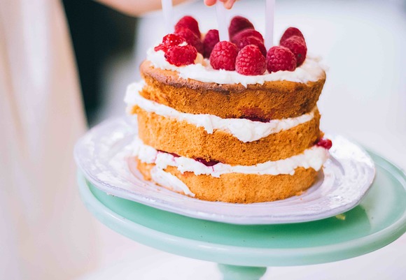 Photo of girl putting a candle on 3 layered cake 776945 kopie